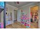 Well-lit bedroom features a bunk bed, walk-in closet, dollhouse, and hardwood flooring at 7728 Whispering River St, Las Vegas, NV 89131
