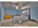 Spacious bedroom featuring a large bed, soft carpet, and plenty of room for furniture at 7728 Whispering River St, Las Vegas, NV 89131