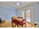 Inviting dining area with a wooden table, six chairs, and sliding glass doors for natural light at 7728 Whispering River St, Las Vegas, NV 89131