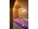 Dog house inside the house with wooden walls, a bed and a toy at 7728 Whispering River St, Las Vegas, NV 89131