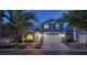 Charming two-story home featuring a two-car garage, well-manicured landscaping, and a welcoming covered front porch at 7728 Whispering River St, Las Vegas, NV 89131