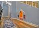 Hallway with a custom dog house underneath the staircase, wood floors and blue accents at 7728 Whispering River St, Las Vegas, NV 89131
