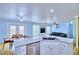 Open kitchen flows into the dining and living areas; features granite countertops and stainless appliances at 7728 Whispering River St, Las Vegas, NV 89131
