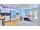 Bright kitchen features white cabinets, stainless steel appliances, and a dining area at 7728 Whispering River St, Las Vegas, NV 89131