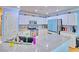 Modern kitchen with white cabinets, stainless steel appliances, and granite countertops at 7728 Whispering River St, Las Vegas, NV 89131