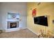 Cozy living room features fireplace, large flat screen TV, and comfortable seating at 7728 Whispering River St, Las Vegas, NV 89131