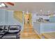 Open-concept living space with hardwood floors, a staircase, and a glimpse of the kitchen at 7728 Whispering River St, Las Vegas, NV 89131