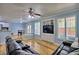 Spacious living room featuring hardwood floors, a ceiling fan, a built-in entertainment center and two couches at 7728 Whispering River St, Las Vegas, NV 89131