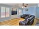 Cozy living room featuring a sectional sofa, built-in shelving, and shuttered windows at 7728 Whispering River St, Las Vegas, NV 89131