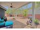 Cozy covered patio with ceiling fan, stone flooring, and outdoor seating, perfect for relaxing and entertaining at 7728 Whispering River St, Las Vegas, NV 89131