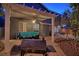 This covered patio features cozy outdoor seating and a grill, perfect for relaxed entertaining at 7728 Whispering River St, Las Vegas, NV 89131