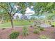 Scenic view of community playground with picnic area, mature trees, and landscaped grounds, perfect for families at 7728 Whispering River St, Las Vegas, NV 89131