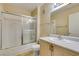 Bright bathroom with a shower-tub, a single sink, and an expansive mirror at 7732 Almeria Ave, Las Vegas, NV 89128