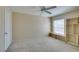 Bright bedroom with neutral walls, ceiling fan, plush carpeting, and custom shelving unit at 7732 Almeria Ave, Las Vegas, NV 89128