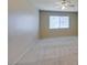 This neutrally decorated bedroom features an overhead fan and ample natural light at 7732 Almeria Ave, Las Vegas, NV 89128