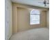 This bedroom features neutral walls and carpet, ceiling fan, and a window for natural light at 7732 Almeria Ave, Las Vegas, NV 89128