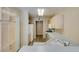 Functional kitchen with white countertops, light wood cabinets, and standard appliances at 7732 Almeria Ave, Las Vegas, NV 89128