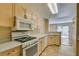 Well-lit kitchen with ample counter space, oven and view into the living area at 7732 Almeria Ave, Las Vegas, NV 89128