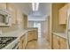 Well-equipped kitchen featuring plenty of cabinet space, oven and view into the living area at 7732 Almeria Ave, Las Vegas, NV 89128