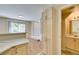 Bright kitchen featuring a breakfast bar, and a view into the entryway and adjacent bathroom at 7732 Almeria Ave, Las Vegas, NV 89128