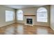 Inviting living room with a fireplace and arched windows at 7732 Almeria Ave, Las Vegas, NV 89128