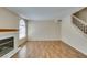 Living room featuring wood flooring, a fireplace, and a staircase to the second floor at 7732 Almeria Ave, Las Vegas, NV 89128