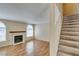Spacious living room with fireplace and a staircase leading to the upper level at 7732 Almeria Ave, Las Vegas, NV 89128