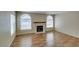 Open living room with fireplace, wood flooring, and plenty of natural light at 7732 Almeria Ave, Las Vegas, NV 89128