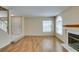 Open living room featuring wood floors, a fireplace, and a staircase at 7732 Almeria Ave, Las Vegas, NV 89128