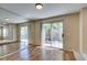 Bright living room with hardwood floors and sliding glass doors to the backyard at 7732 Almeria Ave, Las Vegas, NV 89128