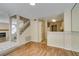 Open-concept living space with stairs, partial kitchen view, and hardwood floors at 7732 Almeria Ave, Las Vegas, NV 89128