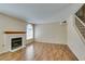 Living room with fireplace, hard surface flooring, and staircase at 7732 Almeria Ave, Las Vegas, NV 89128