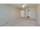 This main bedroom features an ensuite bathroom, neutral carpet, and a ceiling fan at 7732 Almeria Ave, Las Vegas, NV 89128
