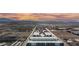Expansive aerial view of the buildings complex, desert, and mountains during a scenic sunset at 8113 Misty Canyon Ave, Las Vegas, NV 89113