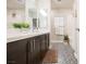 Stylish bathroom featuring double sinks, dark cabinets, and patterned tile floor at 8113 Misty Canyon Ave, Las Vegas, NV 89113