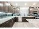 Modern kitchen featuring stainless steel appliances, gray cabinets, granite countertops, and decorative backsplash at 8113 Misty Canyon Ave, Las Vegas, NV 89113