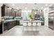 Modern kitchen with a large island, seating, and stainless steel appliances at 8113 Misty Canyon Ave, Las Vegas, NV 89113