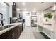 Well-lit kitchen with stainless steel appliances, dark wood cabinets, granite countertops, tile floors, and decorative accents at 8113 Misty Canyon Ave, Las Vegas, NV 89113