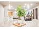 Open-concept living area with access to the dining area and kitchen, and modern light fixture at 8113 Misty Canyon Ave, Las Vegas, NV 89113