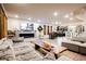 Wide view of the open concept living room showing modern decor, fireplace, dining, and kitchen areas at 8113 Misty Canyon Ave, Las Vegas, NV 89113
