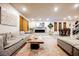 Open concept living room with modern furnishings, decor, and fireplace adjacent to the kitchen at 8113 Misty Canyon Ave, Las Vegas, NV 89113