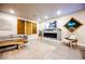 Spacious living room featuring modern decor, TV, fireplace, and wood-look tile floors at 8113 Misty Canyon Ave, Las Vegas, NV 89113