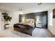 Comfortable bedroom with decorative wall paneling, ceiling fan, neutral tones, and carpeted floors at 8113 Misty Canyon Ave, Las Vegas, NV 89113