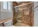 Bathroom featuring a toilet and tiled shower with glass door and built-in niche at 8409 Insignia Ave # 102, Las Vegas, NV 89178