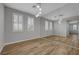 Bright bedroom with wood floors, modern lighting, and large mirror at 8409 Insignia Ave # 102, Las Vegas, NV 89178