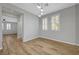 Cozy bedroom with wood floors, natural lighting, and access to other rooms at 8409 Insignia Ave # 102, Las Vegas, NV 89178