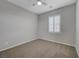 Bright bedroom features neutral walls and carpet and a ceiling fan at 8409 Insignia Ave # 102, Las Vegas, NV 89178