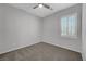 Bedroom featuring a ceiling fan, window with shutters, gray walls, and neutral carpet at 8409 Insignia Ave # 102, Las Vegas, NV 89178