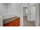 Hallway with gray walls, carpet, and a wood cabinet with granite top at 8409 Insignia Ave # 102, Las Vegas, NV 89178