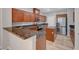 Charming kitchen featuring wood cabinets, granite countertops, and stainless steel appliances at 8409 Insignia Ave # 102, Las Vegas, NV 89178
